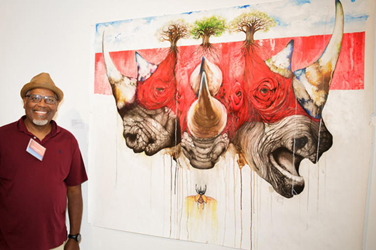Anthony burks poses with his art