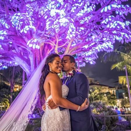 Bride and groom kissing under the wishing tree