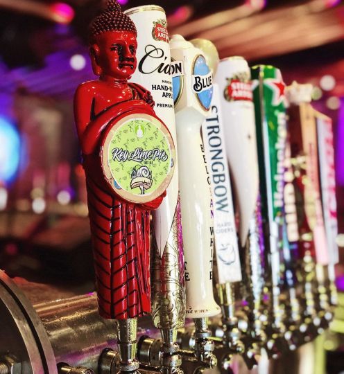 variety of beer taps at bar