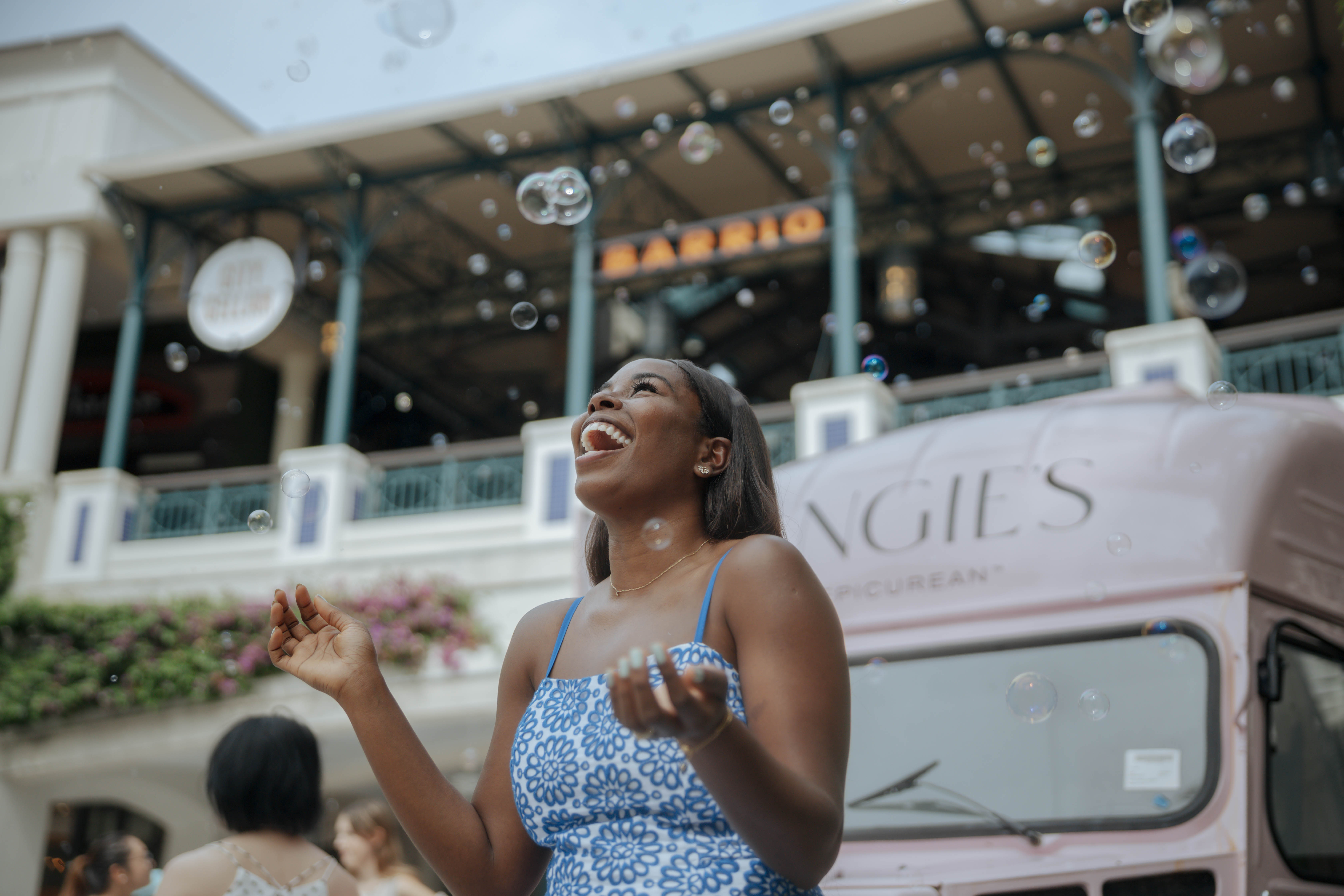 Woman standing surrounded by bubbles