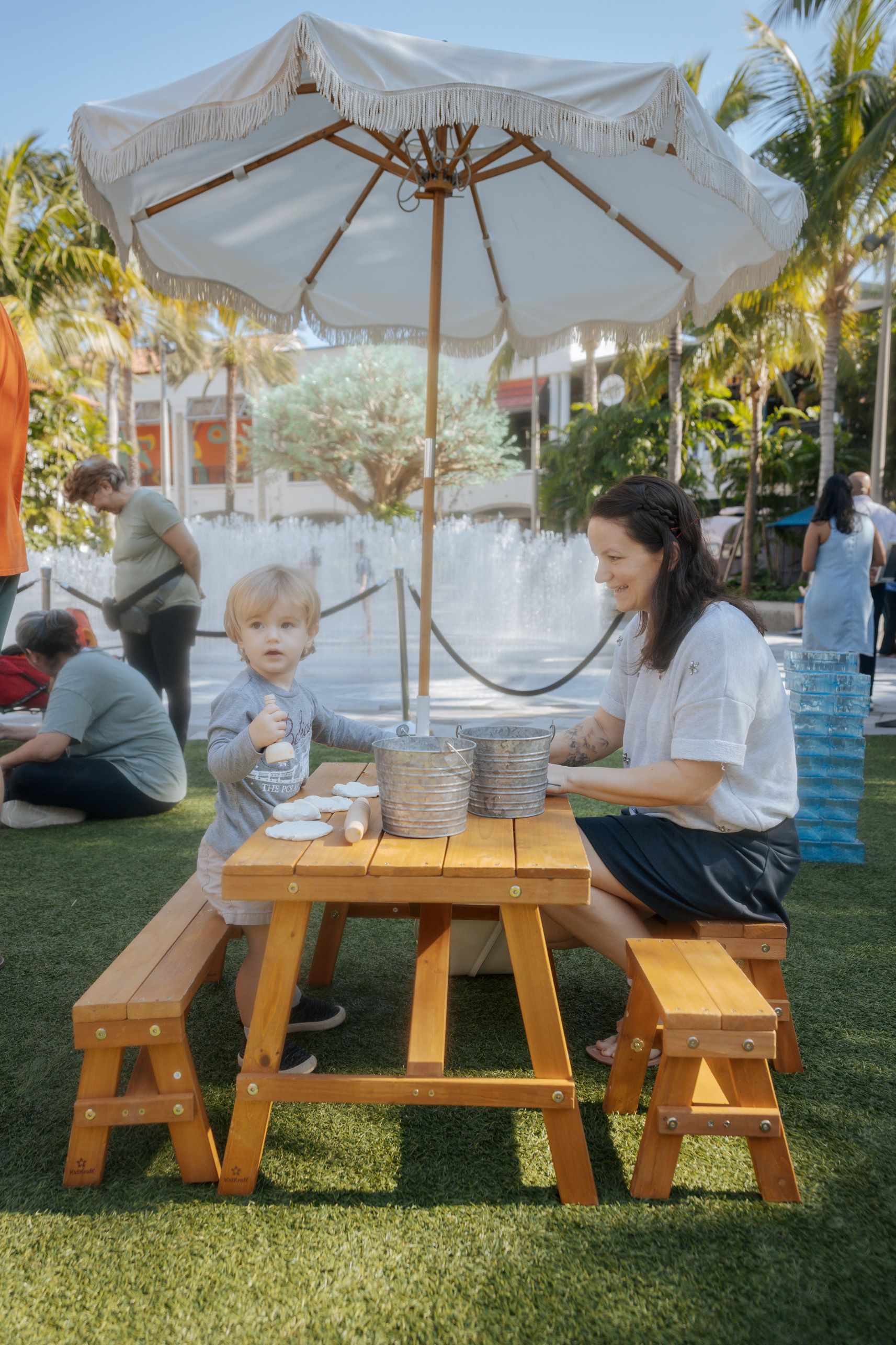 Child and parent playing at water table station