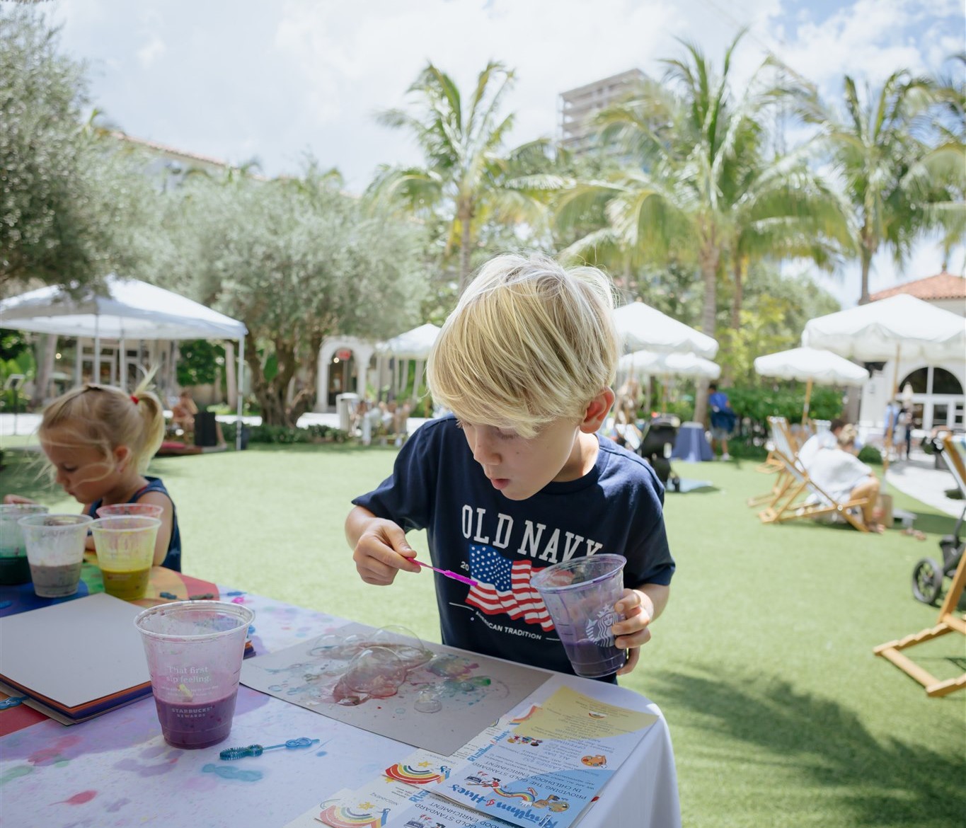 Kid doing a bubble activity on the lawn