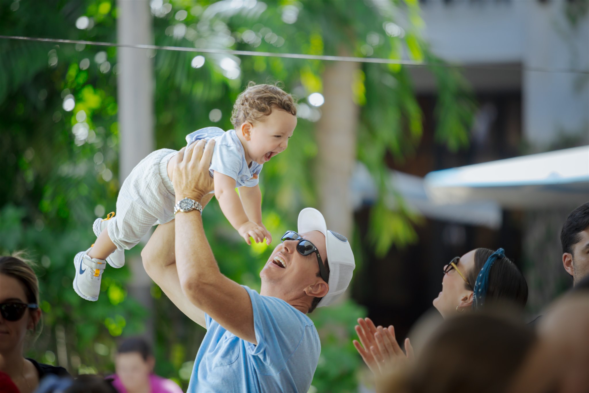 Man holding his baby up in the air