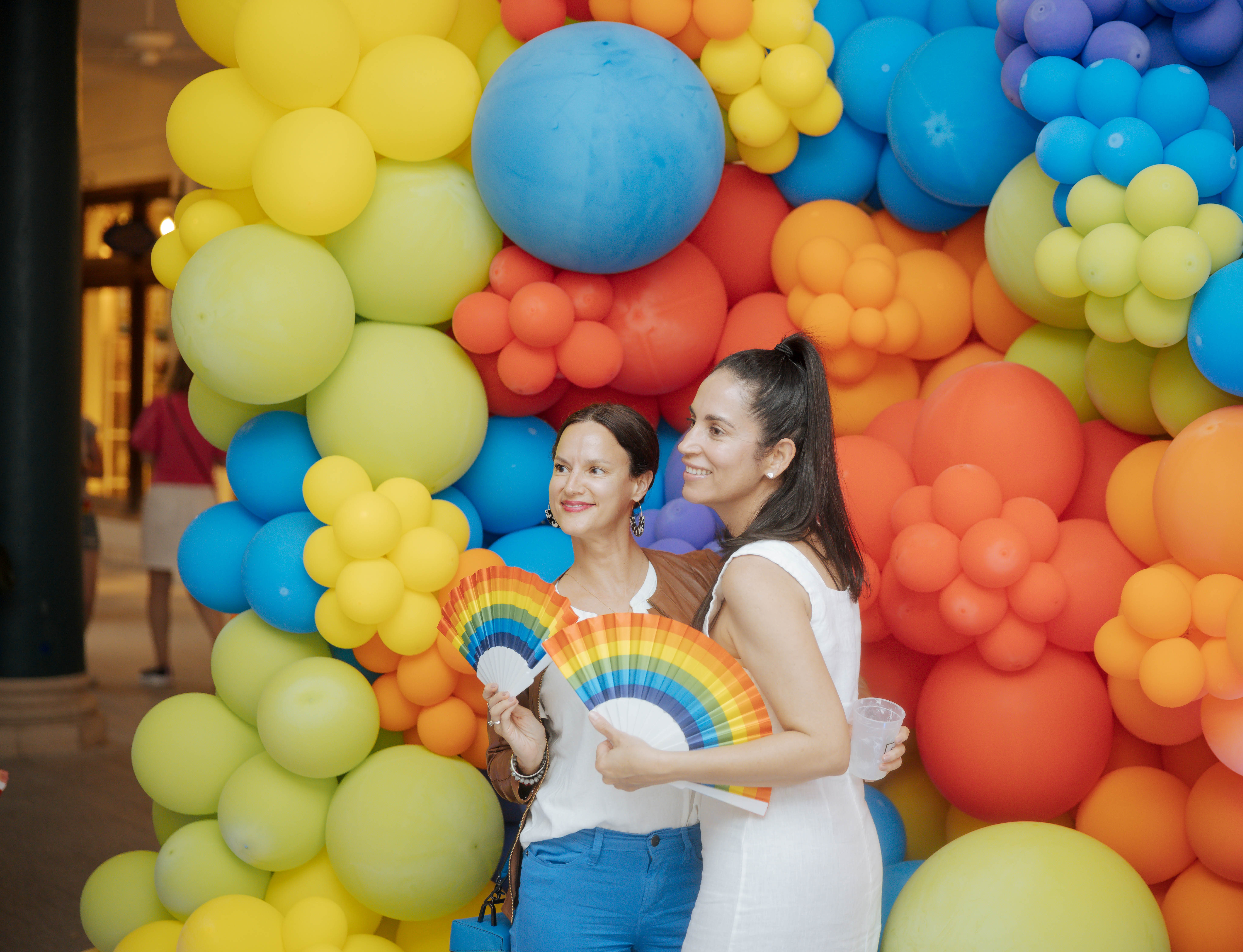 Two women in front of a balloon wall