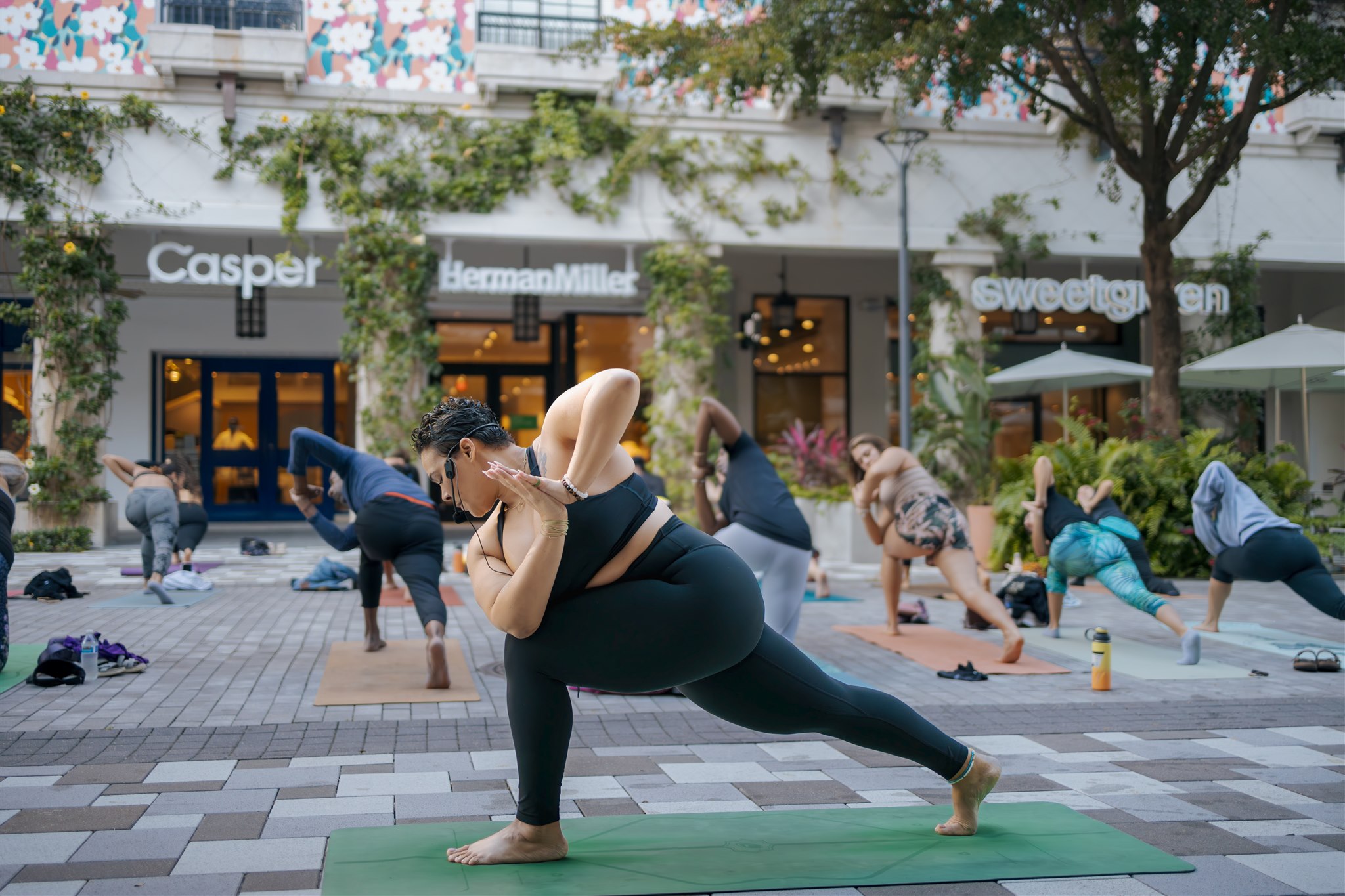 person doing yoga pose infront of yoga class