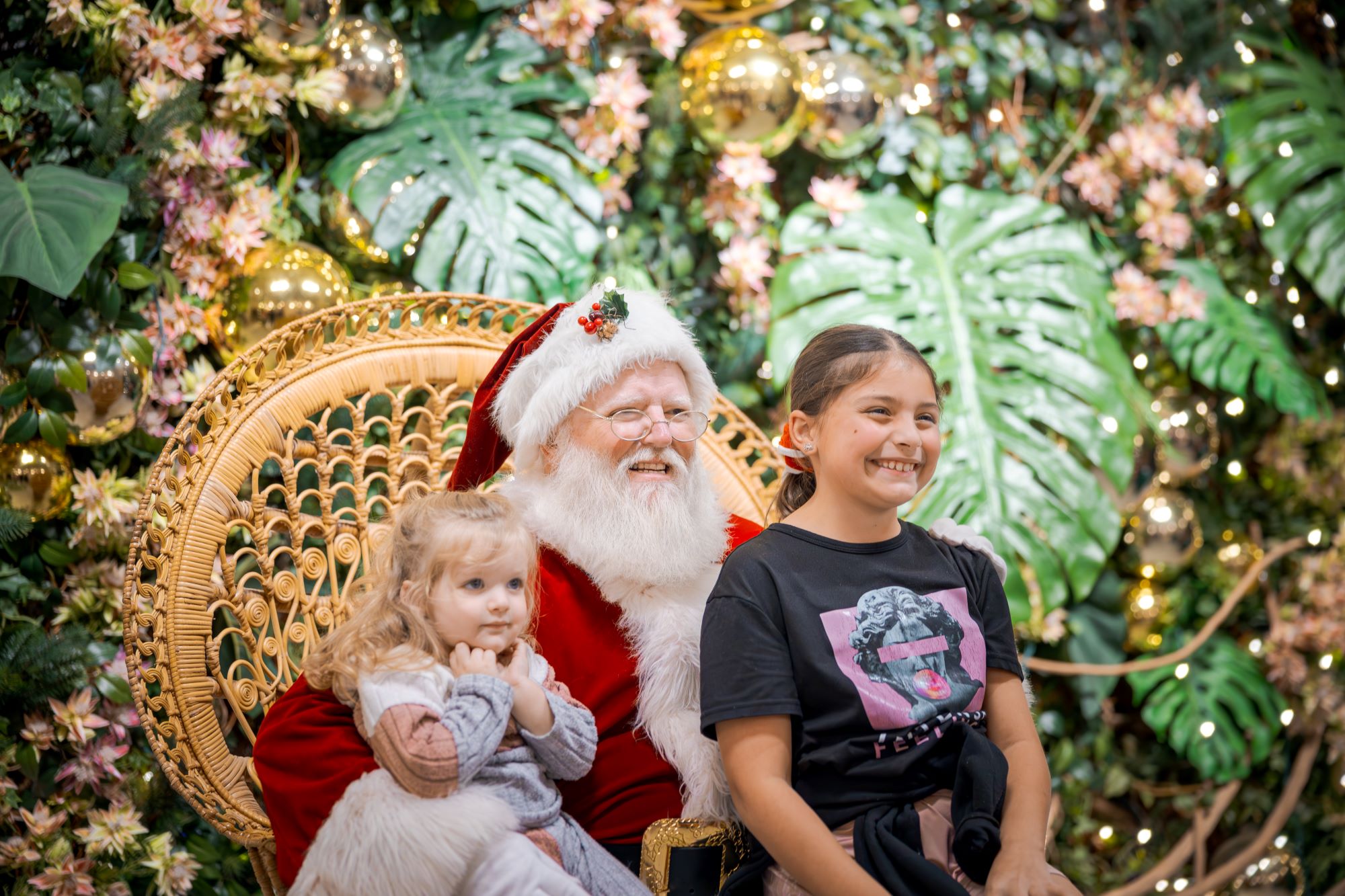 Two children taking a photo with Santa