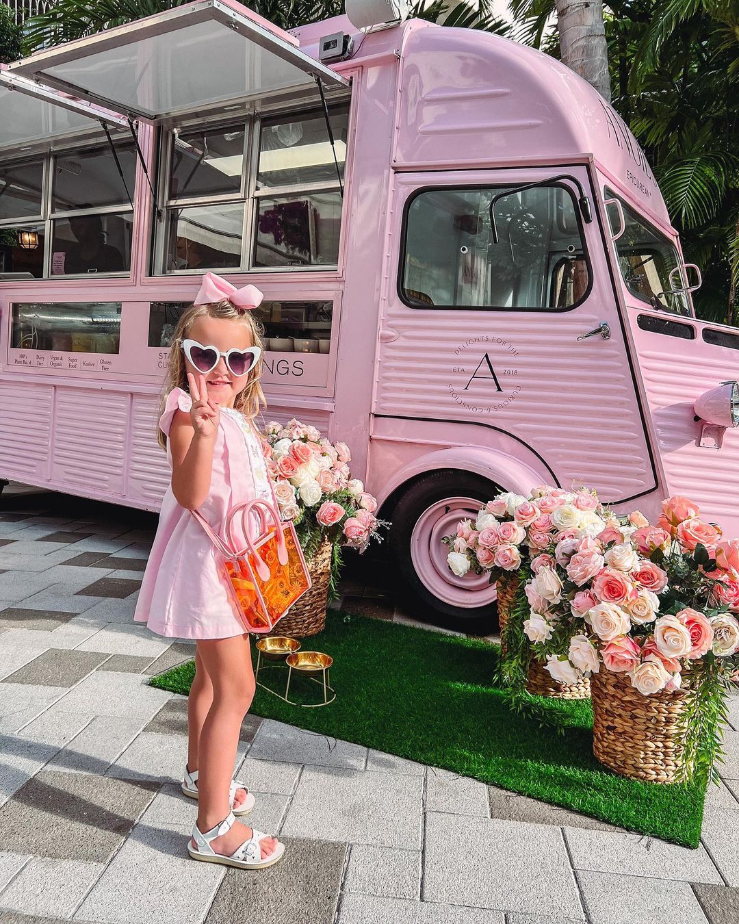 Child posing in front of Angie's truck