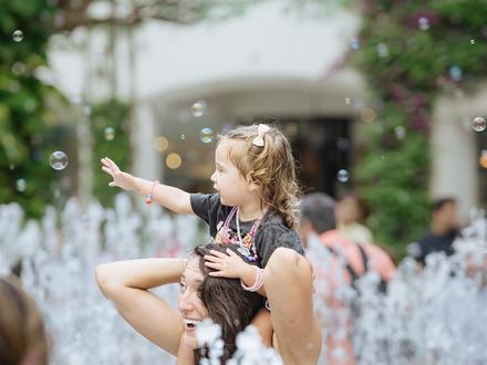 Mom and daughter playing in a fountain