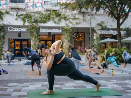 person doing yoga pose infront of yoga class