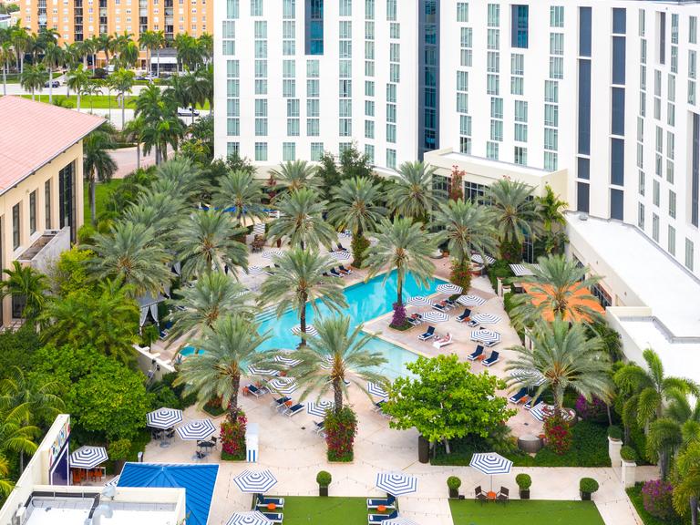 Aerial photo of hotel pool and green lawn