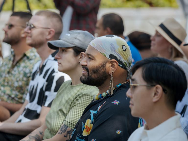 Crowd of people watching a panel discussion