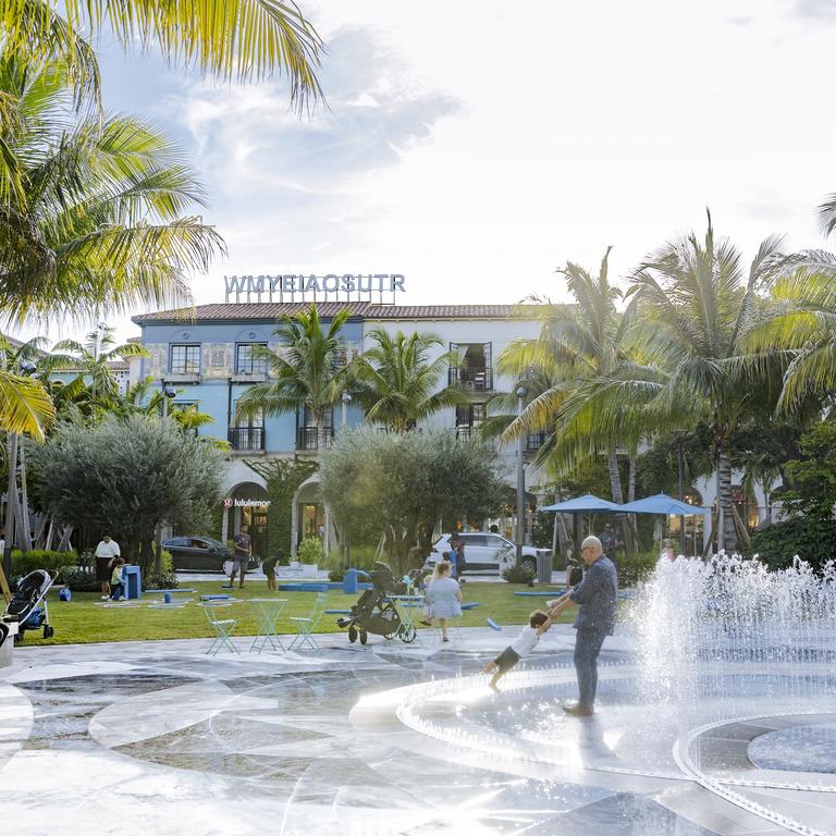 Families playing in water fountain 