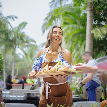 Woman holding a tray of food samples